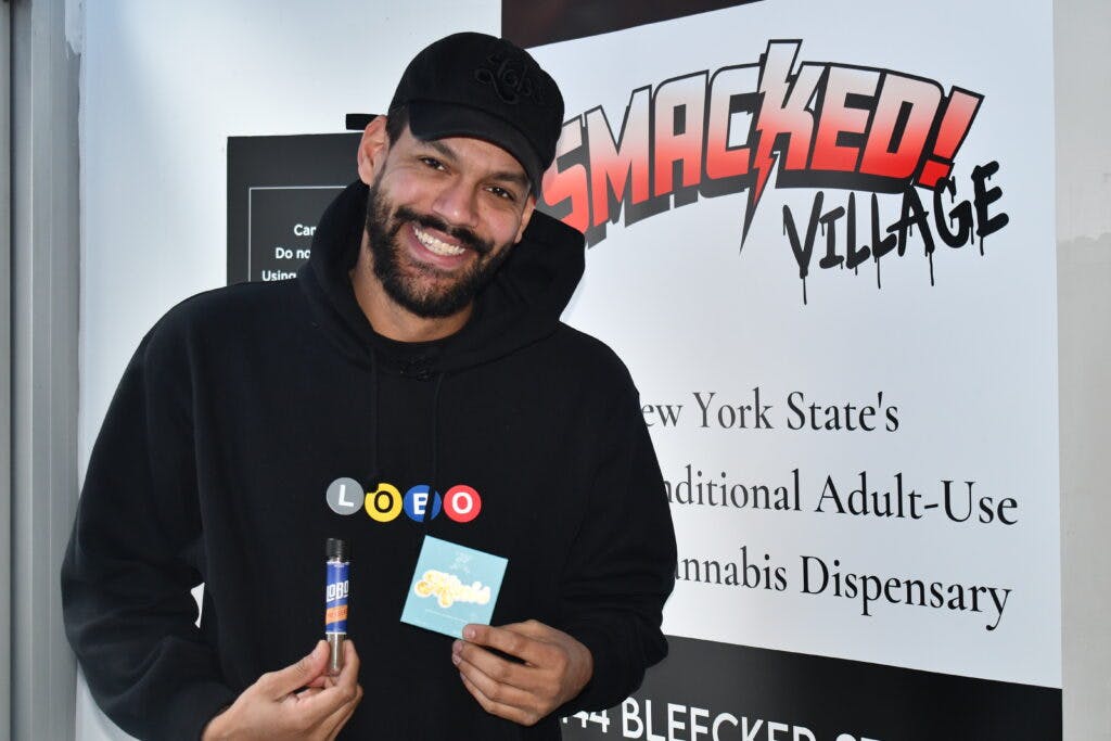 Eduardo Whittington is the co-founder of Lobo Cannagars. Here he poses with his products at Smacked Village in New York. (Calvin Stovall / Leafly)